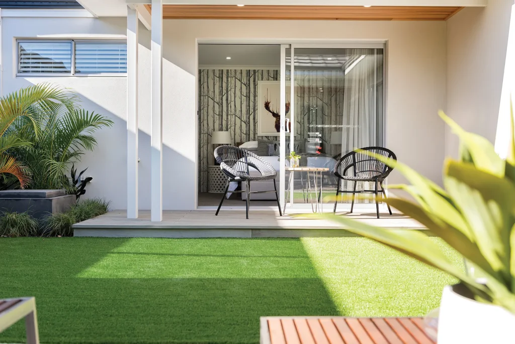 Modern patio with chairs and green lawn