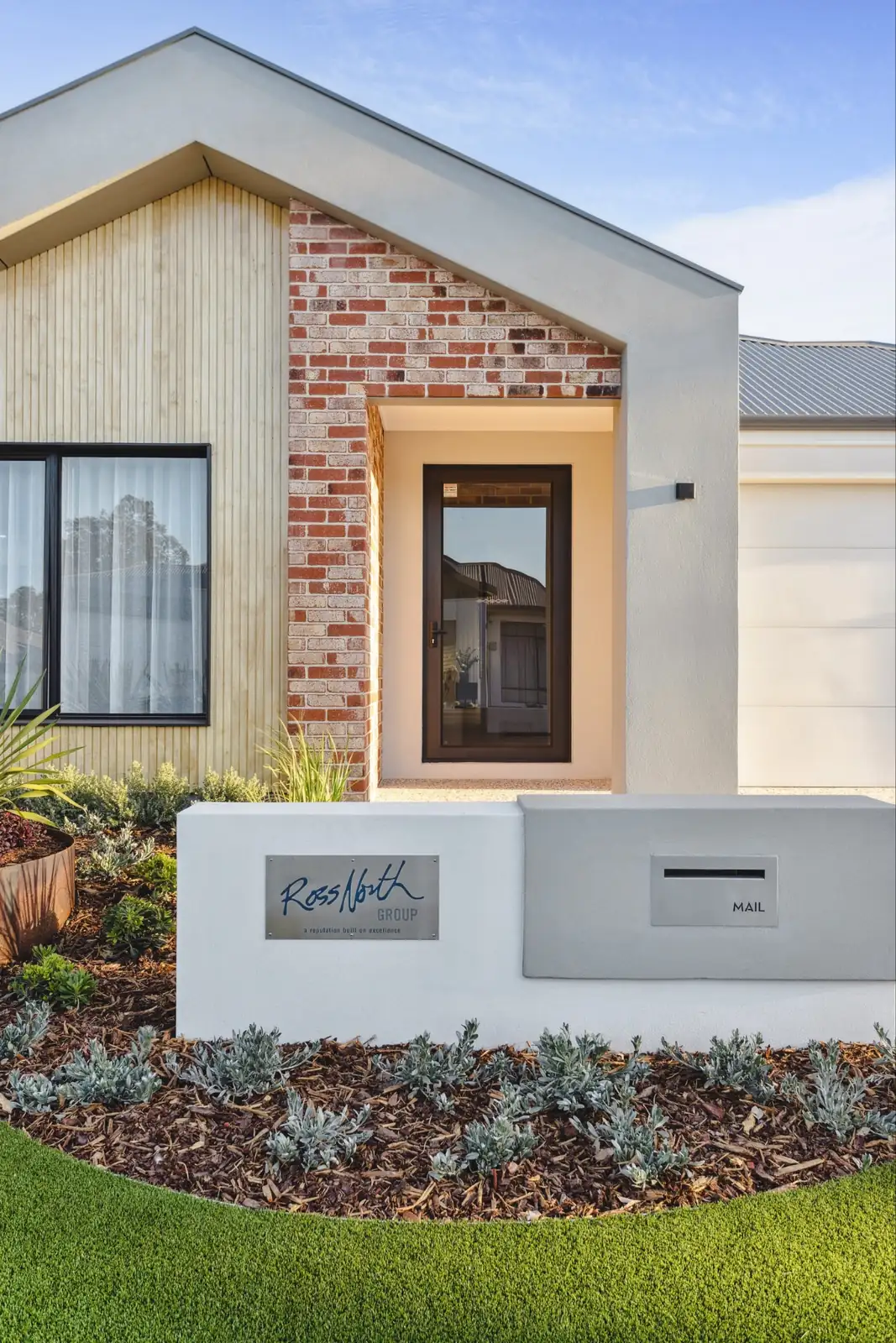 Front entry of a Perth home with a brick feature, timber cladding and covered porch for shade