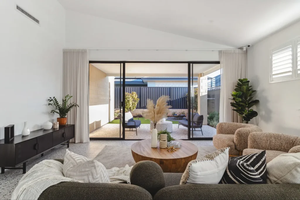 Living area with sliding doors opening to a shaded alfresco in a Perth home