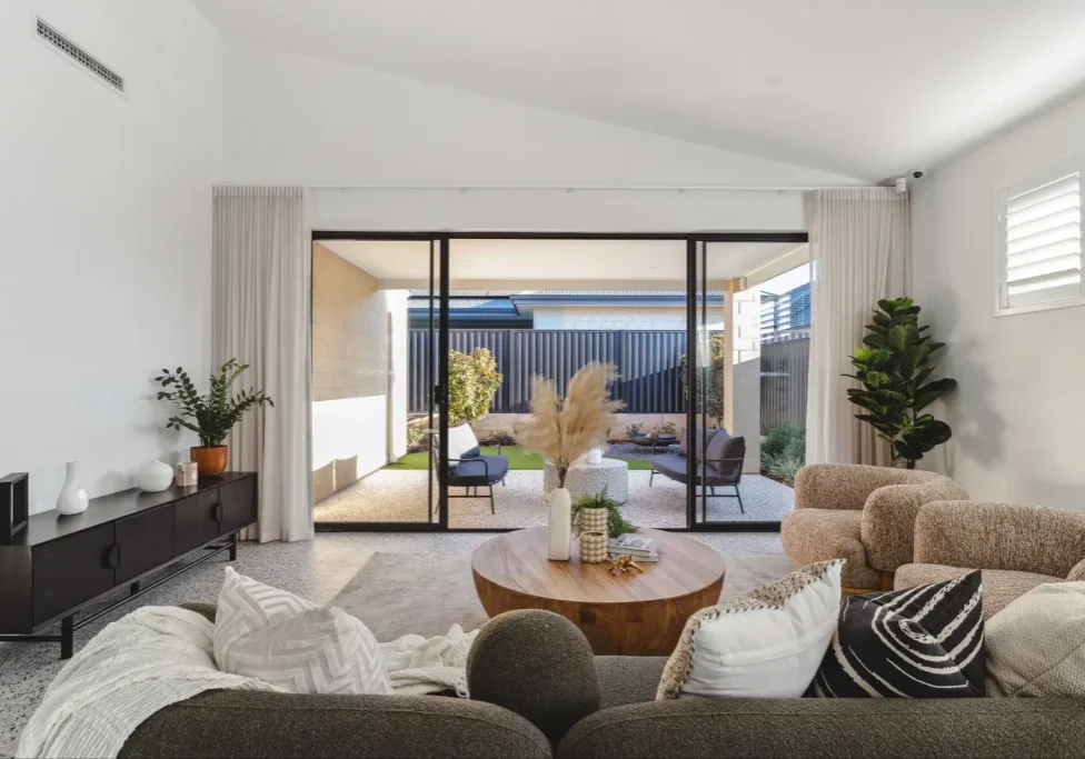 Living area with sliding doors opening to a shaded alfresco in a Perth home